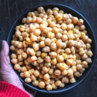 An overhead shot of chickpeas in a black bowl