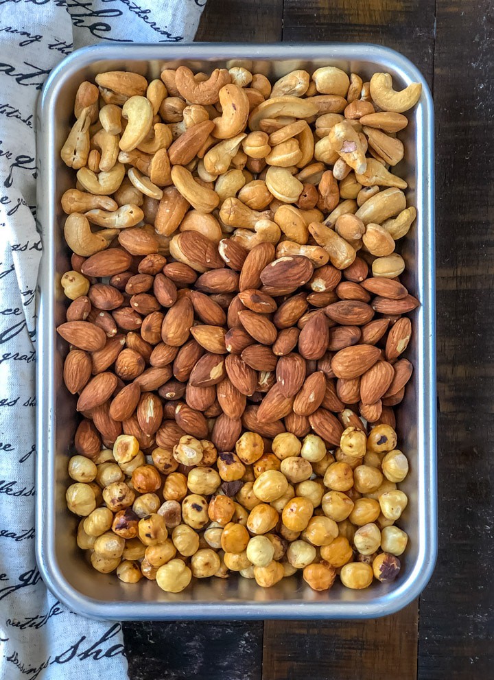 An overhead shot of roasted cashews, almonds and hazelnuts