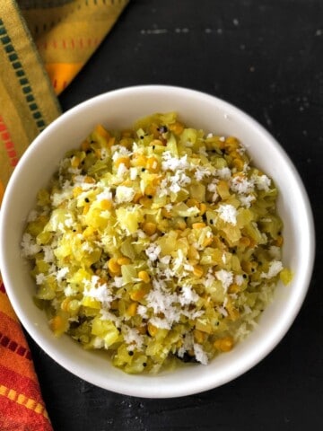An overhead shot of cabbage kootu served in a white bowl