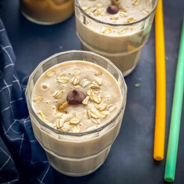 Peanut Butter Banana smoothie served in a glass topped with chocolate chip morsels and rolled oats