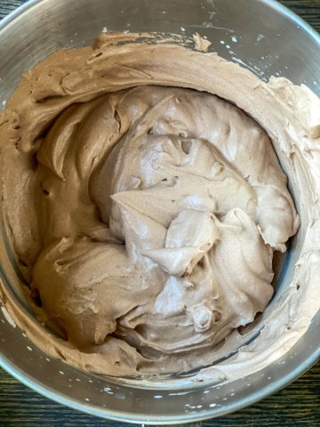 A mixing bowl with chocolate ice cream before it gets frozen.