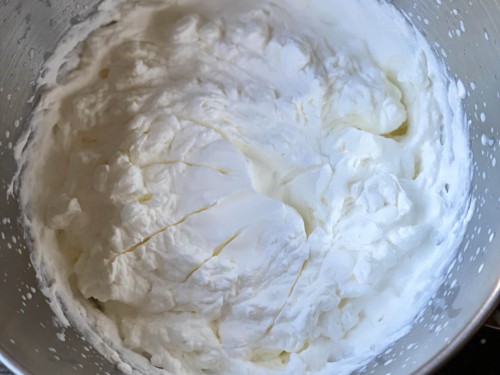 Whipped cream in a mixing bowl.