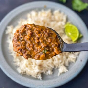 A ladle filled with langar ki dal