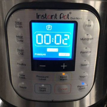 An Instant pot with 2 minutes showing on the panel.