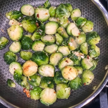 Brussel sprouts being sauteed in a pan