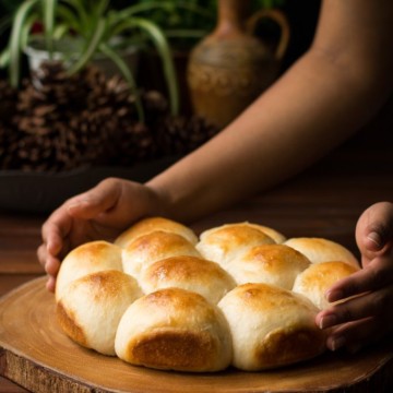 Dinner rolls served on a wooden platter