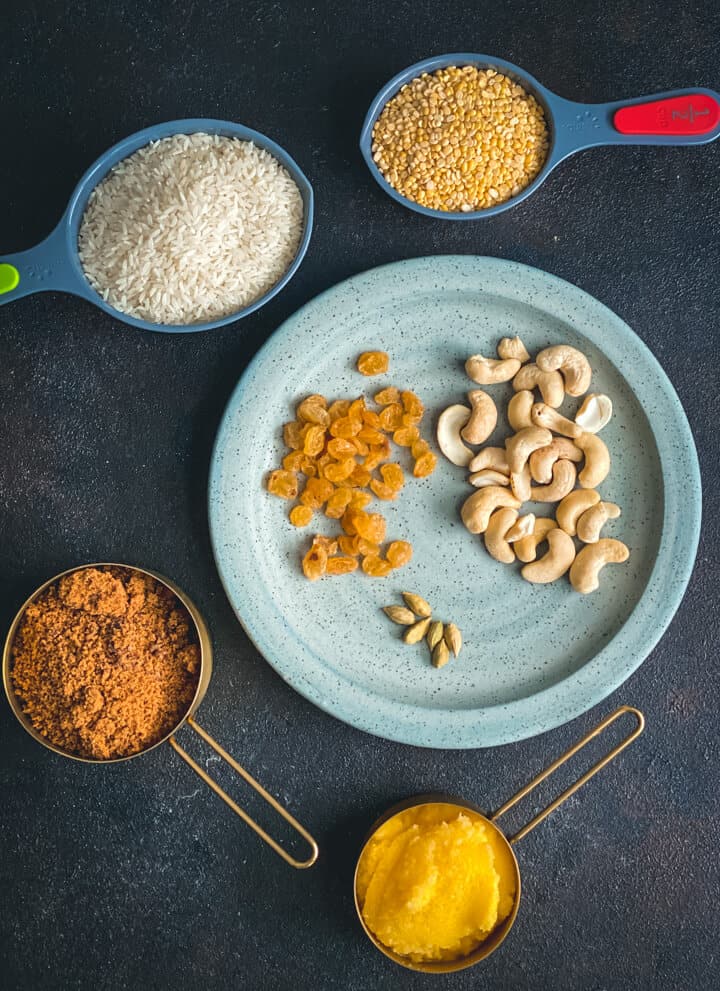 Image of ingredients used in Sweet Pongal - rice, moong dal, powdered jaggery, raisins,cashews, green cardamom and ghee
