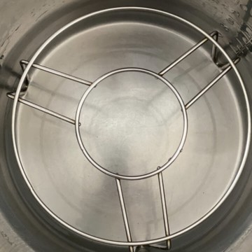 A trivet in an instant pot with water.