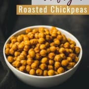 A white bowl with air fryer roasted chickpeas on a black towel and the words Air Fryer Roasted Chickpeas at the top.