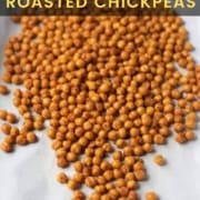 A white towel with crispy roasted chickpeas spilled out on the towel with the words Spicy and Crunchy Roasted Chickpeas at the top.