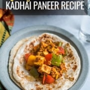 A blue plate with parathas topped with kadhai paneer a glass of water to the right and a wok with more kadai panner above with the words easy Kadhai paneer recipe at the top.