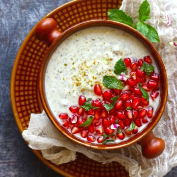 mint raita with pomegranate seeds as garnish