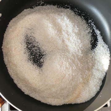 Desiccated coconut on a non-stick pan