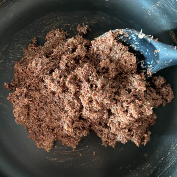 Coconut-Chocolate mixture with a ladle in a non stick pan