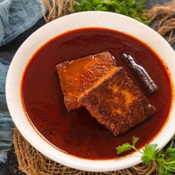 Kashmiri laal paneer curry served in a white bowl