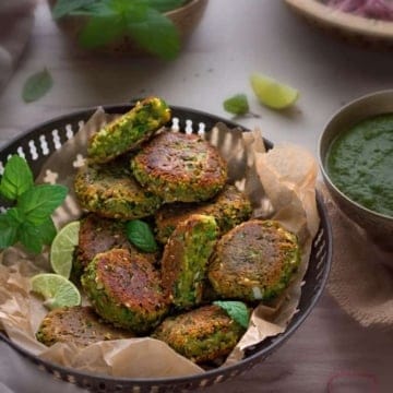 Kababs served with lime wedges and mint leaves