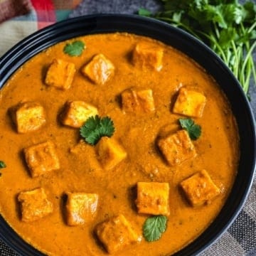 Paneer tikka masala in a black bowl