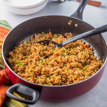 A skillet full of vegetable fried rice.