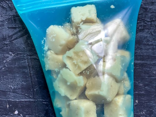 Garlic cubes stored in a reusable freezer bag.