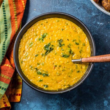 An overhead image of a bowl of Moong Dal garnished with cilantro.
