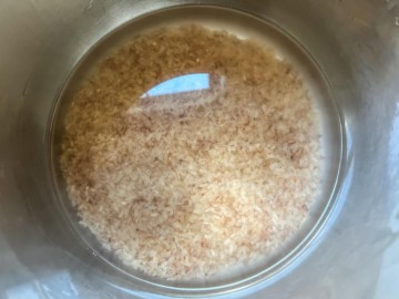 Water and rinsed red rice in the Instant Pot inner pot.
