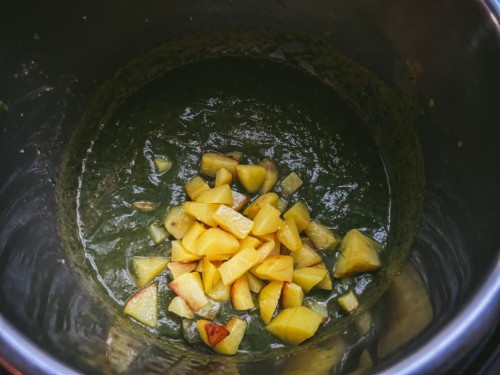 Potatoes on top of blended spinach curry.