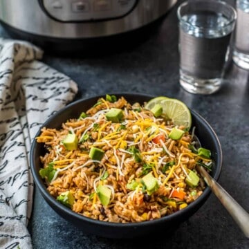 A bowl of Mexican Rice with beans, garnished with lime.