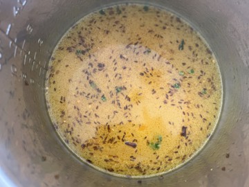 Adding water and dal to an Instant Pot.