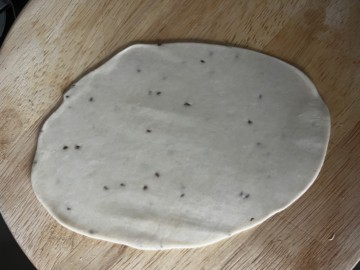Rolling dough into an oval.