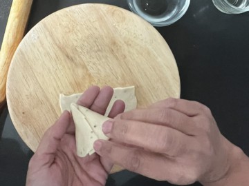 Shaping a dough into a cone.