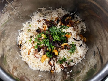 Adding onions, cashews, and raisins to an Instant Pot with rice.