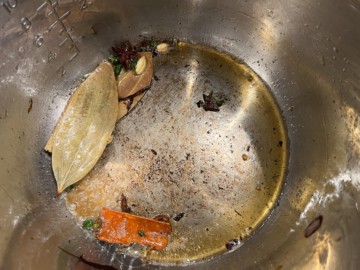 Adding aromatics to ghee inside of an Instant Pot.