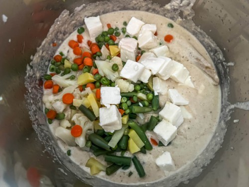 Paneer cubes and veggies with cashew sauce added to instant pot.
