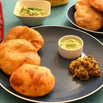 Mangalore buns served with two chutneys in a blue plate