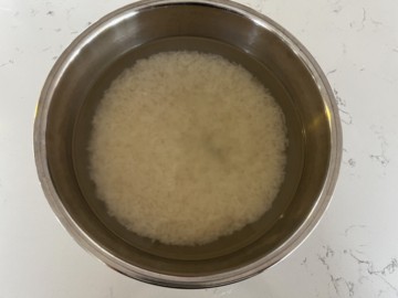 Top down view Instant Pot with soaked rice.