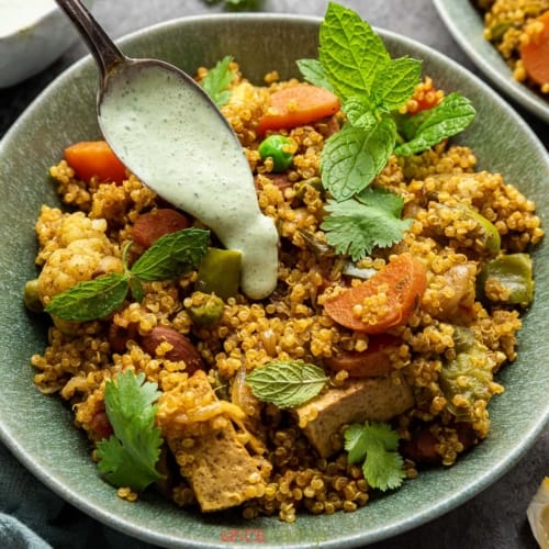 Quinoa Vegetable Biryani served in a green bowl