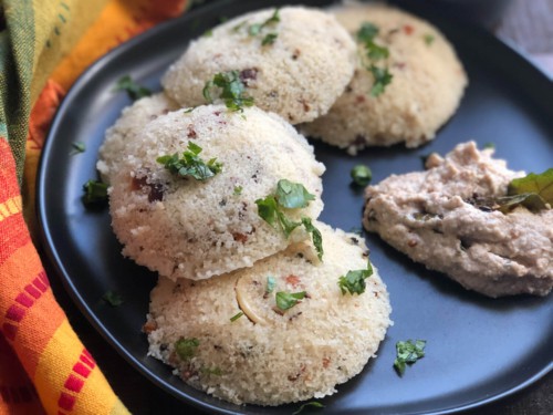 3 Rava Idlis served with chutney in a black plate