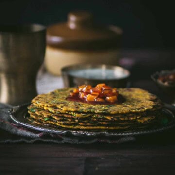 Methi thepla served with chundo on top and yogurt on the side